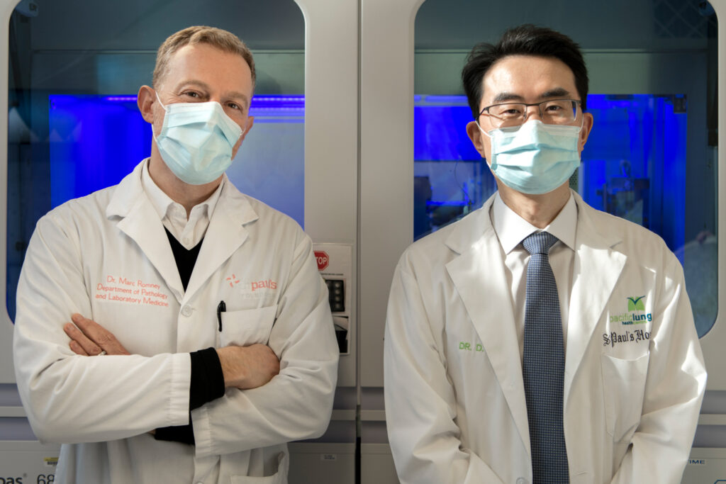 Two doctors wearing masks standing side-by-side