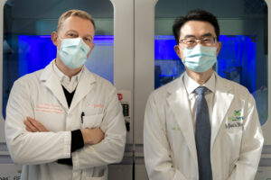 Two doctors wearing masks standing side-by-side